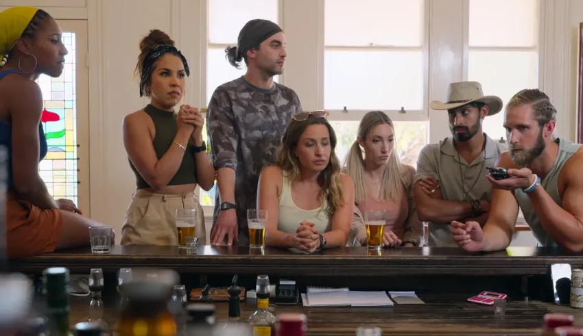 A group of people sitting around a bar.